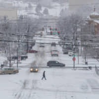 A pedestrian crosses Seventh Street in downtown Rapid City, South Dakota, on Wednesday. | RAPID CITY JOURNAL / VIA AP