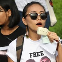 Thinzar Shun Lei Yi speaks at a march for press freedom in Yangon on Sept. 1. | REUTERS