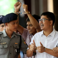 Detained Reuters journalist Wa Lone and Kyaw Soe Oo arrive at Insein court in Yangon, Myanmar, on Aug. 27. | REUTERS