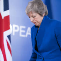 British Prime Minister Theresa May departs after a news conference following a special meeting of the European Council on the Brexit withdrawal agreement in Brussels, Belgium, on Nov. 25. | BLOOMBERG
