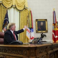 U.S. President Donald Trump speaks in the Oval Office at the White House in Washington on Tuesday. | BLOOMBERG