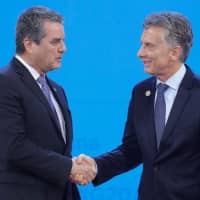 WTO Director-General Roberto Azevedo is welcomed by Argentine President Mauricio Macri at Costa Salguero in Buenos Aires during the G20 summit on Friday. | AFP-JIJI