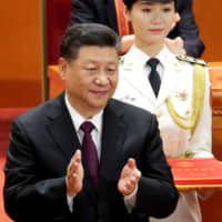 Chinese President Xi Jinping applauds at an event marking the 40th anniversary of China\'s reform and opening up at the Great Hall of the People in Beijing on Tuesday. | REUTERS