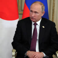 Russian President Vladimir Putin attends a meeting with Prime Minister Shinzo Abe in Buenos Aires on Saturday. | REUTERS