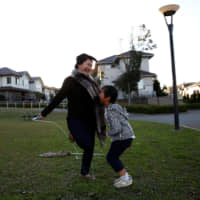 Mariko Hirose jumps rope with her son, Naohito, at a park in Higashinohara district of Inzai, Chiba Prefecture, on Nov. 1. | REUTERS