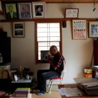Katsuya Kodama prays in front of an altar for his late wife at his house in the Sennari district on Aug. 29. | REUTERS