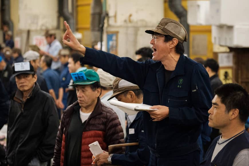 An auctioneer yells during the final tuna auction at the landmark Tsukiji fish market on its last day of operations before it closed for relocation.