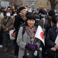 Thousands of people lined up to witness the celebration of Emperor Akihito\'s 85th birthday. | RYUSEI TAKAHASHI