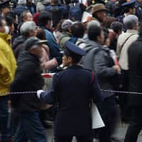 Police usher crowds to the Imperial Palace grounds on Sunday. | RYUSEI TAKAHASHI