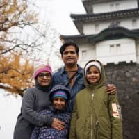 Runa Ashish (left) and her family were visiting Japan this past week. It was their first time in the country, and coming from India, she said it was interesting to see the love and adoration the Japanese people have for the Emperor.  | RYUSEI TAKAHASHI