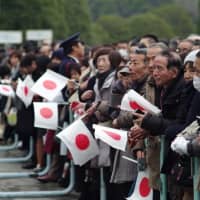 People wait to catch a glimpse of Emperor Akihito on his 85th birthday. | RYUSEI TAKAHASHI