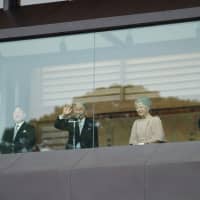 Emperor Akihito waves to the public during his 85th birthday celebration. | RYUSEI TAKAHASHI