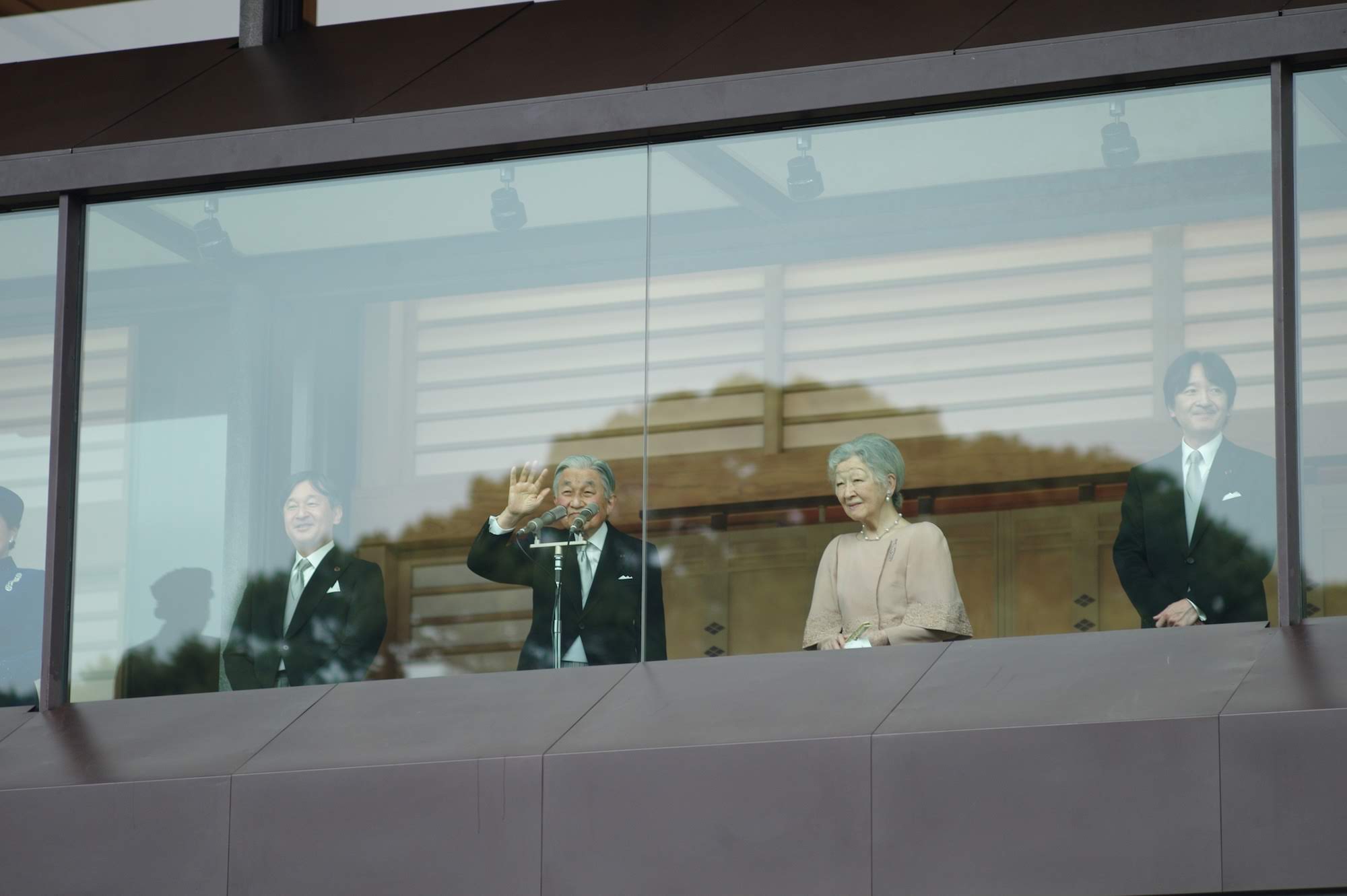 Emperor Akihito waves to the public during his 85th birthday celebration.