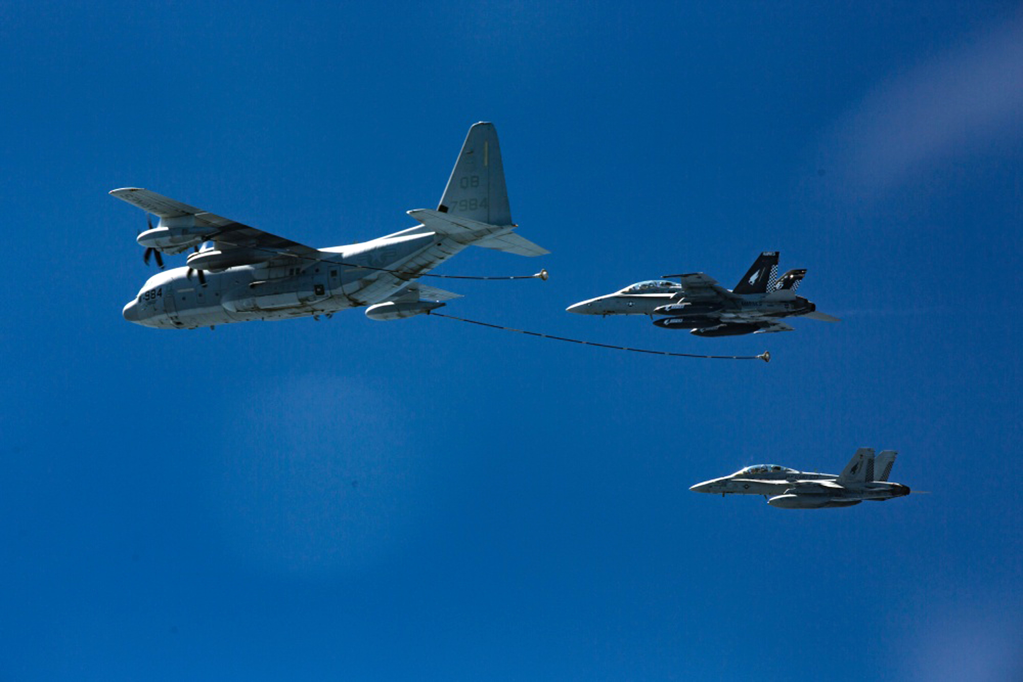 Two U.S. Marine F/A-18 fighter jets approach a KC-130 tanker during a refueling exercise in October 2016. | AP