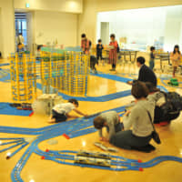 Families play with Plarail laid out by Purafesu organizers in the city of Saitama on Saturday. | ANDREW MCKIRDY