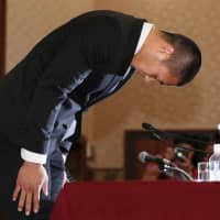 Nihon University defensive end Taisuke Miyagawa bows deeply on May 22 at the Japan National Press Club, where he apologized for an illegal tackle and revealed he was forced to make the controversial play by his coach, Masato Uchida. | KYODO
