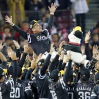 Fukuoka SoftBank Hawks manager Kimiyasu Kudo is tossed in the air after his team won the Japan Series title in November. | KYODO