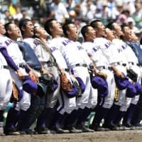 Members of Kanaashi Nogyo bend backward while singing their school anthem after winning a game at the National High School Baseball Championship at Koshien Stadium in August. | KYODO