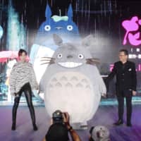Koji Hoshino (right), chairman of Studio Ghibli Inc., appears at an event in Shanghai on Monday to announce that \"My Neighbor Totoro\" will be played at movie theaters in China from Dec. 14. | KYODO