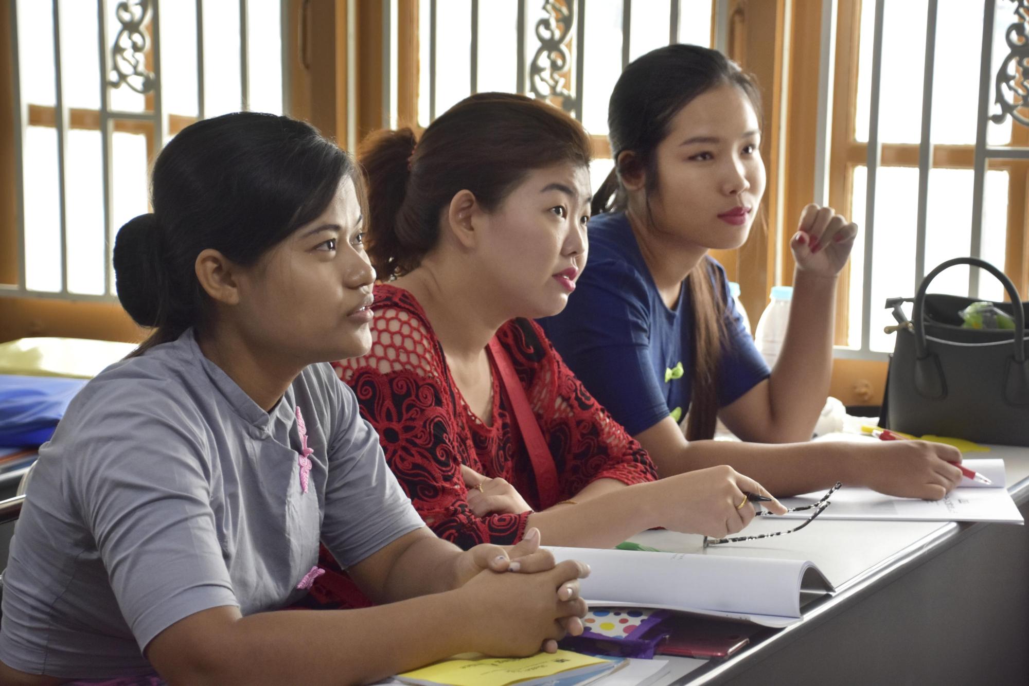 Myanmar women planning to go to Japan as foreign trainees and work as caregivers study Japanese at a school in Yangon in May. | KYODO