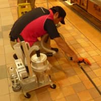 A cleaning staff member uses a newly developed vomit-cleaning vacuum. | JR EAST ENVIRONMENT ACCESS CO.