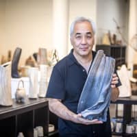 Akira Satake holds an example of his work at his studio in Asheville, North Carolina. | COURTESY OF AKIRA SATAKE