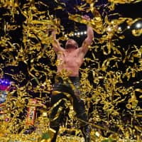 Kenny Omega celebrates after winning a fight at Tokyo\'s Ryogoku Kokugikan in October. | COURTESY OF NEW JAPAN PRO-WRESTLING