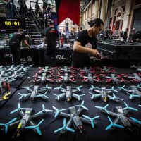 Drone Racing League officials check equipment at one of the organization\'s events in 2018. | COURTESY OF DRONE RACING LEAGUE
