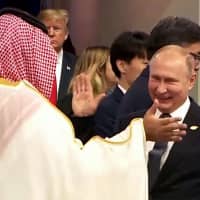 Russian President Vladimir Putin and Saudi Crown Prince Mohammed bin Salman greet each other at the Group of 20 summit in Buenos Aires on Nov. 30 as U.S. President Donald Trump looks on. | AFP-JIJI