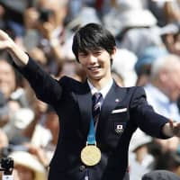 Hometown hero: Figure skating champion Yuzuru Hanyu takes part in a parade in Sendai in April. | KYODO