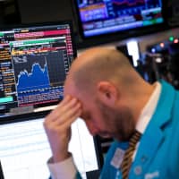 A trader works on the floor of the New York Stock Exchange on Dec. 19 as U.S. stocks careened to a 15-month low amid worries over the Federal Reserve\'s monetary policy. | BLOOMBERG