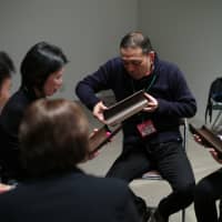 Masaru Seto (center) passes a ball to a teammate during a problem-solving exercise at an interview session for applicants for the 2019 Rugby World Cup volunteer program in Tokyo on Monday. RYSUEI TAKAHASHI | RYUSEI TAKAHASHI