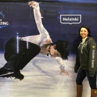 American fan Nicole Zarate poses by a poster of Yuzuru Hanyu in Helsinki during the Grand Prix event there in November. | COURTESY OF NICOLE ZARATE