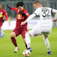 Salzburg striker Takumi Minamino contents with Altach\'s Felix Luckeneder for the ball on Sunday in Salzburg, Austria. | KYODO