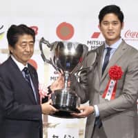 Prime Minister Shinzo Abe and Shohei Ohtani of the Los Angeles Angels pose for a photo at the Japan Pro Sports Awards on Thursday in Tokyo. Ohtani received the Prime Minister Cup for the second time. | KYODO
