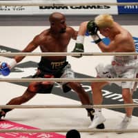 Floyd Mayweather (left) goes on the offensive against Tenshin Nasukawa during an exhibition bout on Monday at Saitama Super Arena. Mayweather won in the first round by technical knockout. | REUTERS