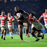 The Brave Blossoms received a test of their development for the 2019 Rugby World Cup against Joe Cokanasiga (center) and England on Nov. 17 in Twickenham, England. | REUTERS