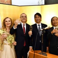 Mohamed El Amine Bencherif, Algerian ambassador to Japan (second from left), and his wife, Amira (left), raise a toast with Kenji Yamada, parliamentary vice-minister for foreign affairs (second from right), and Akira Urabe, president of the Japan-Algeria Association and former ambassador to Algeria (right), during a reception at the embassy to celebrate Algeria\'s 64th national day on Nov. 16. | YOSHIAKI MIURA