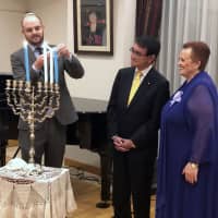Foreign Minister Taro Kono (center) joins Israelian Ambassador Yaffa Ben-Ari (right) at a special Hanukkah candle lighting reception hosted at the Israeli ambassador\'s residence on Dec. 4. | COURTESY OF THE EMBASSY OF ISRAEL