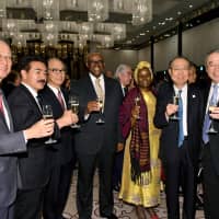 Kenyan Ambassador S.K. Maina (center) and his wife, Rose Maina (third from right), raise a toast with (from left) Jun Karube, chairman of Toyota Tsusho and the honorary consul for Kenya; State Minister for Foreign Affairs Masahisa Sato; Yasuhiko Yokoi, chairman of the Committee on Africa-Japan Relations; Nobuhide Hayashi, chairman of Mizuho; and Nobuhiro Endo, chairman of NEC, during a reception to celebrate Kenya\'s 55th anniversary of independence at the Tokyo Marriott Hotel on Dec. 12. | YOSHIAKI MIURA