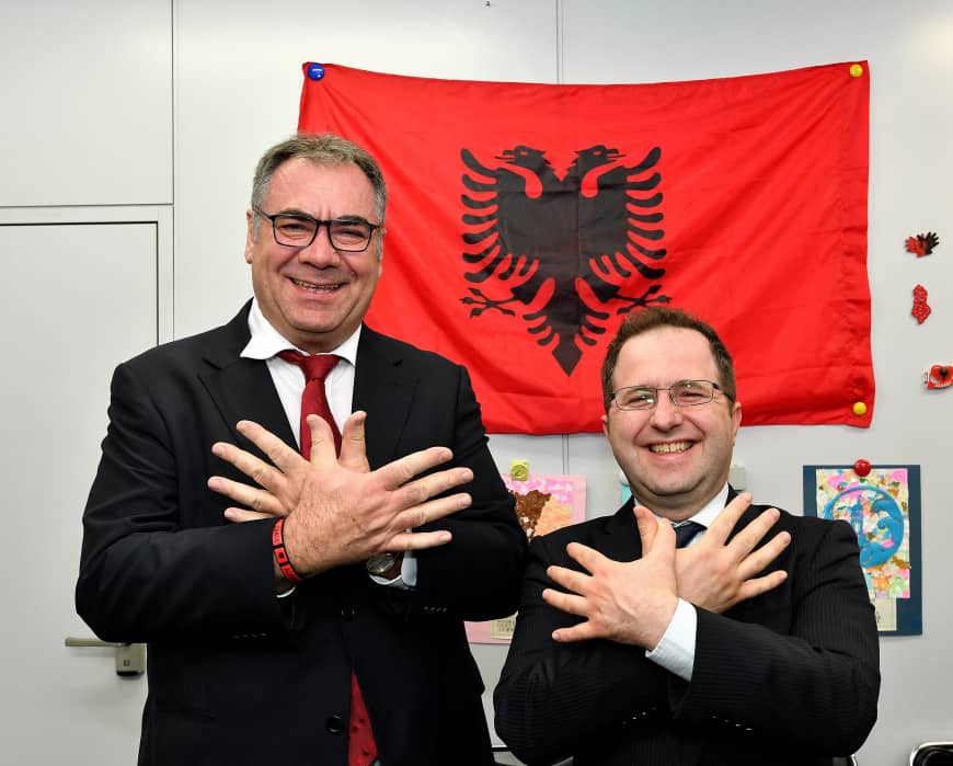 Albanian Ambassador Gjergj Teneqexhiu (left) welcomes Kosovan Ambassador Leon Malazogu (right) during a reception to celebrate Albanian flag day at the embassy in Tokyo on Nov. 30.