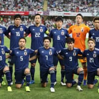 The Japan national team poses for a group picture before the 2019 Asian Cup semifinal match against Iran at Hazza Bin Zayed Stadium in Abu Dhabi on Jan. 28. | AFP-JIJI