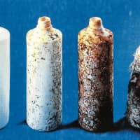 An eco-friendly, biodegradable polylactic acid, which is decomposed by microorganisms found in soil, is under development by Japanese researchers. The bottles pictured represent various stages of the plant-based plastic\'s decomposition. From left &#8212; zero weeks, two weeks, four weeks and six weeks. | JAPAN BIOPLASTICS ASSOCIATION