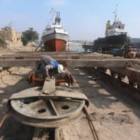 A worker inspects a pulley that pulls ships at a shipyard built by the British Army on Basra\'s docks in 1916, in Basra, Iraq, in December. | REUTERS