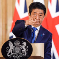 Prime Minister Shinzo Abe attends a joint news conference with Britain\'s leader at the time, David Cameron, at No. 10 Downing St. in London in May 2016. | BLOOMBERG