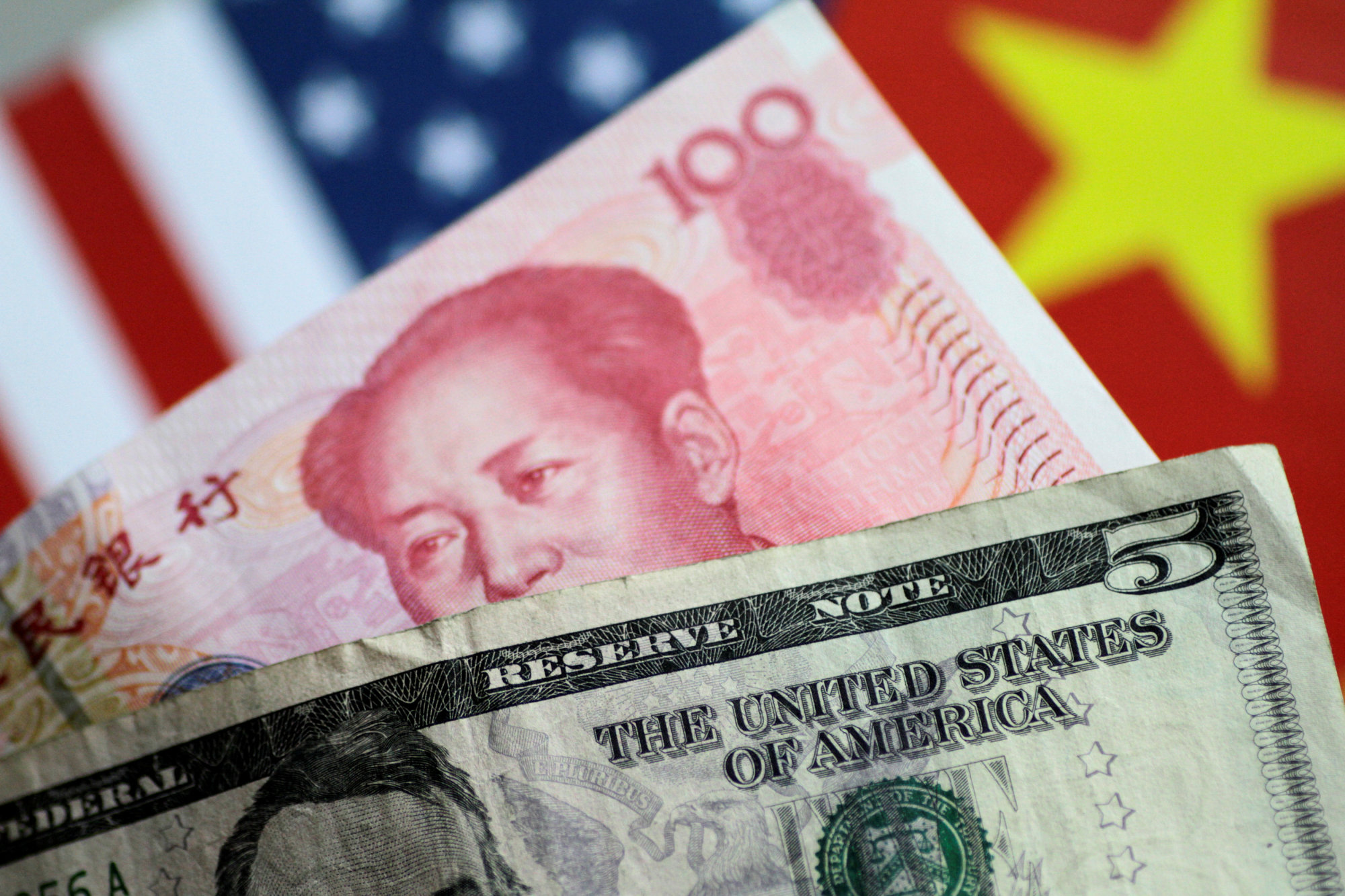 U.S. dollar and China yuan notes are seen in 2017. | REUTERS