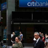 Pedestrians walk past a Citigroup Inc. Citibank branch in the central business district of Sydney Jan. 11. | BLOOMBERG