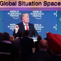 A television screen displays U.S. President Donald Trump delivering a speech on the closing day of the World Economic Forum Annual Meeting in Davos, Switzerland, in January 2018. | BLOOMBERG