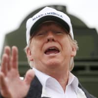 U.S. President Donald Trump talks to reporters as he visits the banks of the Rio Grande River during a visit to the U.S.-Mexico border in Mission, Texas, on Thursday. | REUTERS