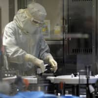 An employee works in an unit dedicated to the production of insulin pens at the factory of the U.S. pharmaceutical company Eli Lilly in Fegersheim, eastern France, in 2015. Pharmaceutical giant Eli Lilly will acquire cancer treatment specialist Loxo Oncology in a cash deal valued at around &#36;8 billion, the companies said on Monday. | AFP-JIJI